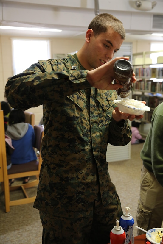 Seaman apprentice Bryce Lewis, student at Field Medical Training Battalion, prepares his ice cream for the Sundaes on Sunday event at the base library aboard Marine Corps Base Camp Johnson, Jan. 26. Sundaes on Sunday is a monthly themed event giving families and service members a place to come on Sunday afternoons to relax, have fun, and eat free ice cream.

