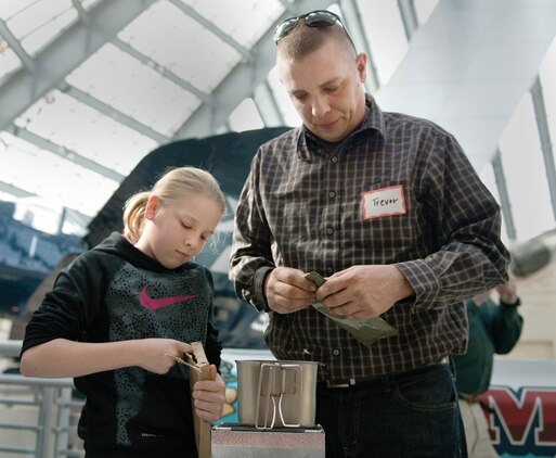 Gunnery Sgt. Trevor Havens and his daughter get ready to compete in the National Museum of the Marine Corps Second Annual MRE Cook-off in Triangle, Va., Feb. 1, 2014. The contest had extra spaces for contestants and Havens volunteered to participate from the crowd.