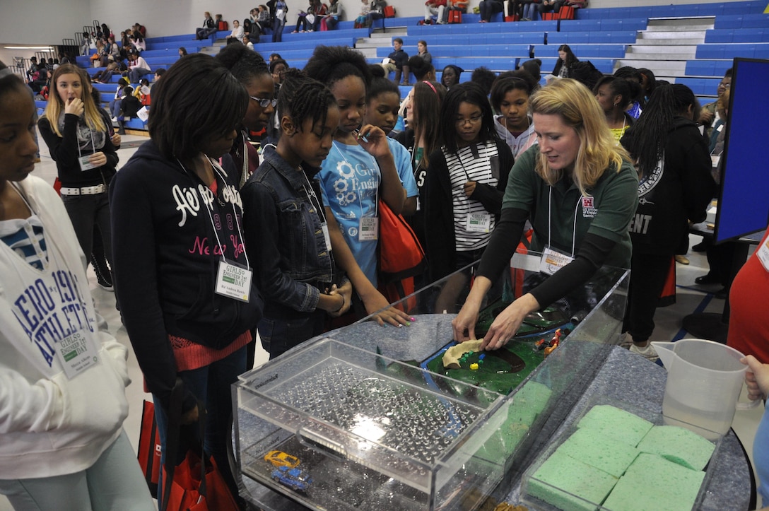 Beth Williams, dam and levee safety program manager for the U.S. Army Corps of Engineers Savannah District, uses a floodplain model to demonstrate the functions of levees at Girls Engineer It Day, Feb. 1. The event reached 350 middle and high-school age females and their parents to promote engineering career fields. USACE photo by Tracy Robillard.

