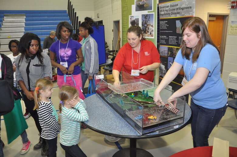 Regulatory Specialists Sherelle Reinhardt (left) and Sarah Wise of the U.S. Army Corps of Engineers Savannah District present an interactive floodplain model at the 3rd Annual Girls Engineer It Day, Feb. 1 at Woodville Tompkins High School. The event reached 350 elementary and middle school-age females and their parents to promote education in STEM (science, technology, engineering and math). USACE photo by Tracy Robillard.