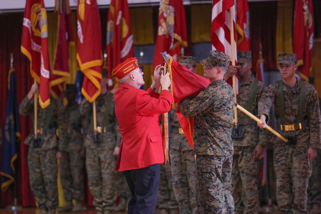 Retired Chief Warrant Officer Alex Nevgloski, from Philadelphia, and now with the Marine Corps League, attaches a battle streamer to the 2nd Marine Division flag during the Battle Colors Rededication Ceremony aboard Marine Corps Base Camp Lejeune, Jan. 31, 2014. Past and present Marines of 2nd Marine Division joined to celebrate the Division’s 73rd birthday. The 2nd Marine Division was officially activated Feb. 1, 1941 at Camp Elliot, Calif., dropping its earlier designation as the 2nd Brigade. The 2nd Marine Division flag shows off a total of 15 streamers ranging from World War II in 1942 to the Global War on Terrorism today.