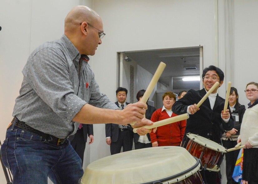 Staff Sgt. Wilfredo Cruz, the United States Air Force Band of the Pacific-Asia drummer, attempts to play the traditional Japanese taiko drum at Tachikawa City, Japan, Feb. 2, 2014.  The performers for Japan - U.S. Joint Concert had the opportunity to make new friends and experience Japanese traditional instruments before the concert.  (U.S. Air Force photo by Airman 1st Class Soo C. Kim / released)