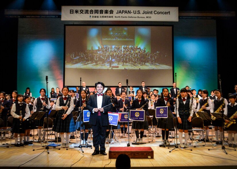 Performers at the Japan - U.S. Joint Concert stand in front of the audience after a musical ensemble at Tachikawa City, Japan, Feb. 2, 2014.  The North Kanto Defense Bureau hosted its annual event and chose building friendships through music as this year’s theme.  (U.S. Air Force photo by Airman 1st Class Soo C. Kim / released)