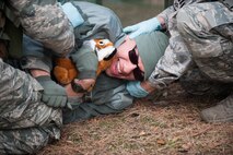 Members of the 8th Medical Group prepare to move Senior Airman Armando Schwier-Morales, 8th Fighter Wing Public Affairs exercise role player, to an ambulance during exercise Beverly Midnight 14-01 at Kunsan Air Base, Republic of Korea, Feb. 5, 2014. The 8th MDG treated all of the victims brought out of a simulated explosion and fire and prepared others for transportation to an off-base hospital. (U.S. Air Force photo by Staff Sgt. Clayton Lenhardt/Released)