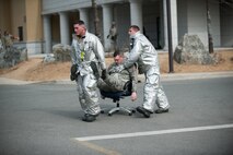 Senior Airman Stephen Heath and Staff Sgt. Jonathan Fackler, 8th Civil Engineer Squadron firefighters, transport an ‘injured’ exercise role player to medical personnel during exercise Beverly Midnight 14-01 at Kunsan Air Base, Republic of Korea, Feb. 5, 2014. The fire department searched for survivors and escorted or carried them to medical personnel for treatment. (U.S. Air Force photo by Staff Sgt. Clayton Lenhardt/Released)
