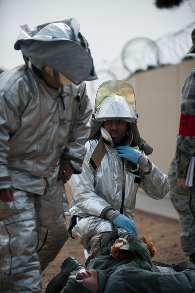 Firefighters from the 8th Civil Engineer Squadron respond to an exercise role player's calls for help during exercise Beverly Midnight 14-01 at Kunsan Air Base, Republic of Korea, Feb. 5, 2014. This exercise was a surprise to the base and is training the Wolf Pack to ensure they are always ready. (U.S. Air Force photo by Staff Sgt. Clayton Lenhardt/Released)