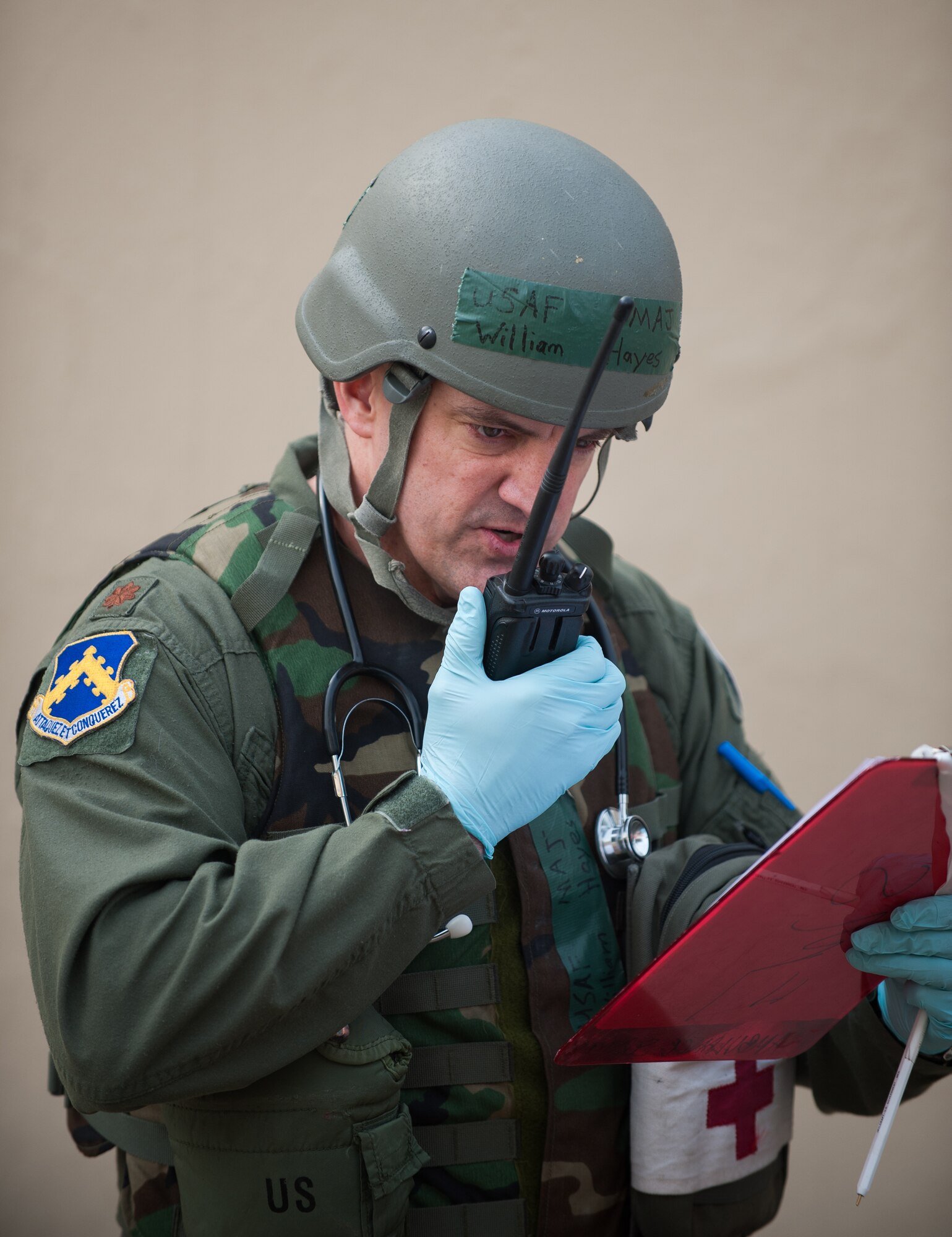 Maj. William Hayes, 8th Medical Group chief of aerospace medicine, reports patient conditions during exercise Beverly Midnight 14-01 at Kunsan Air Base, Republic of Korea, Feb. 5, 2014. The 8th MDG treated all of the victims brought out of a simulated explosion and fire and prepared others for transportation to an off-base hospital. (U.S. Air Force photo by Staff Sgt. Clayton Lenhardt/Released)