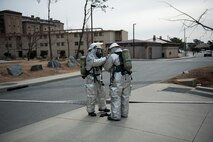 Members of the is it 8th Civil Engineer Squadron fire department conduct buddy checks during exercise Beverly Midnight 14-01 at Kunsan Air Base, Republic of Korea, Feb. 5, 2014. The fire department responded to a simulated dormitory fire started by enemy attack and resulting explosion. (U.S. Air Force photo by Staff Sgt. Clayton Lenhardt/Released)