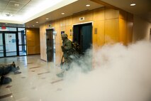 A dormitory resident evacuates after a simulated explosion during exercise Beverly Midnight 14-01 at Kunsan Air Base, Republic of Korea, Feb. 5, 2014. This exercise was a surprise to the base and is training the Wolf Pack to ensure they are always ready. (U.S. Air Force photo by Staff Sgt. Clayton Lenhardt/Released)