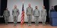 Maj. Jesse Goens, 99th Ground Combat Training Squadron commander, Staff Sgt. Brent Olson, 99 GCTS military working dog instructor, and students, Tech. Sgt. Pedro Guerrero and Staff Sgt. Donald Nachand, stand at attention as the Air Force Achievement Medal citation is read during a ceremony Jan. 31. The three security forces noncommissioned officers were recognized for their first aid efforts which were cited as critical to saving a man’s life after his heart stopped at McCarran International Airport Jan. 6. (U.S. Air Force photo by Tech. Sgt. S.E.)