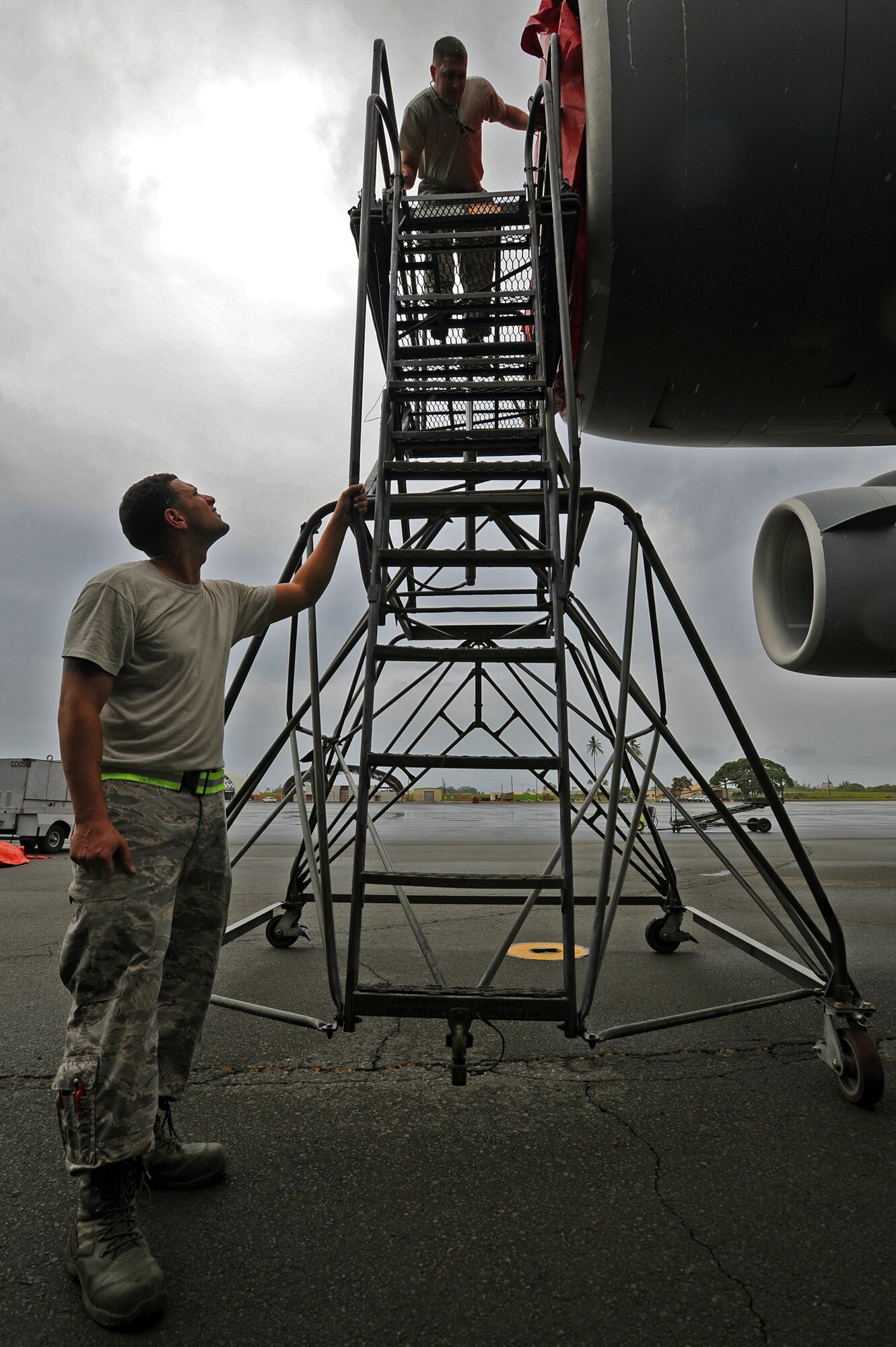 Staff Sgt. Patrick Morrissey, 15th Aircraft Maintenance Squadron crew chief, left and Staff Sgt. Travis Crang, 15th Aircraft Maintenance Squadron crew chief, right, prepare to remove a C-17 Globemaster III engine cover prior to performing preflight checks on the aircraft on the flightline at Joint Base Pearl Harbor-Hickam, Hawaii, Feb. 4, 2014. The C-17 is capable of rapid strategic delivery of troops and all types of cargo to main operating bases or directly to forward bases in the deployment area. (U.S. Air Force photo/Master Sgt. Jerome S. Tayborn)