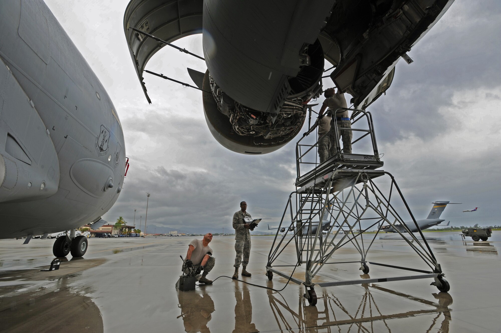 Airmen from the 15th Aircraft Maintenance Squadron prepare to close the thrust reverse and engine accessory doors of a C-17 Globemaster III prior to performing routine maintenance on the aircraft on the flightline at Joint Base Pearl Harbor-Hickam, Hawaii, Feb. 4, 2014. The mission of the 15th Wing is to develop and sustain combat-ready Airmen, in partnership with the total force, to provide global mobility, global reach, precision engagement, and agile combat support ANYTIME, ANYWHERE. (U.S. Air Force photo/Master Sgt. Jerome S. Tayborn)