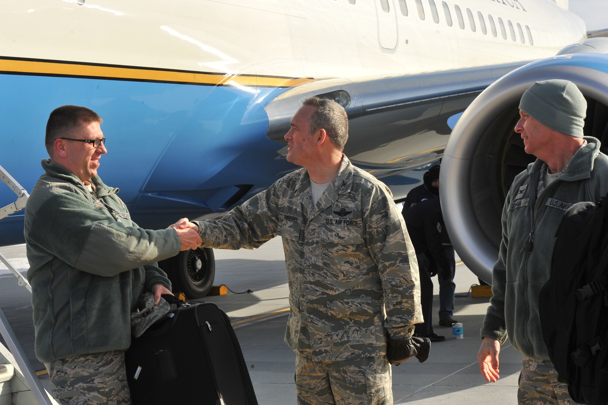 Col. Brian Newberry, 92nd Air Refueling Wing commander, and Col. Daniel Swain, 141st ARW commander, greet a member of Air Mobility Command’s Inspector General team as they arrive for the Unit Effectiveness Inspection Feb. 5, 2014 at Fairchild Air Force Base, Wash. The Fairchild UEI will continue through Feb. 14.  Inspectors from the AMC IG office will be inspecting compliance, continuous improvement and self-assessment programs. (U.S. Air Force photo by Staff Sgt. Veronica Montes/Released)