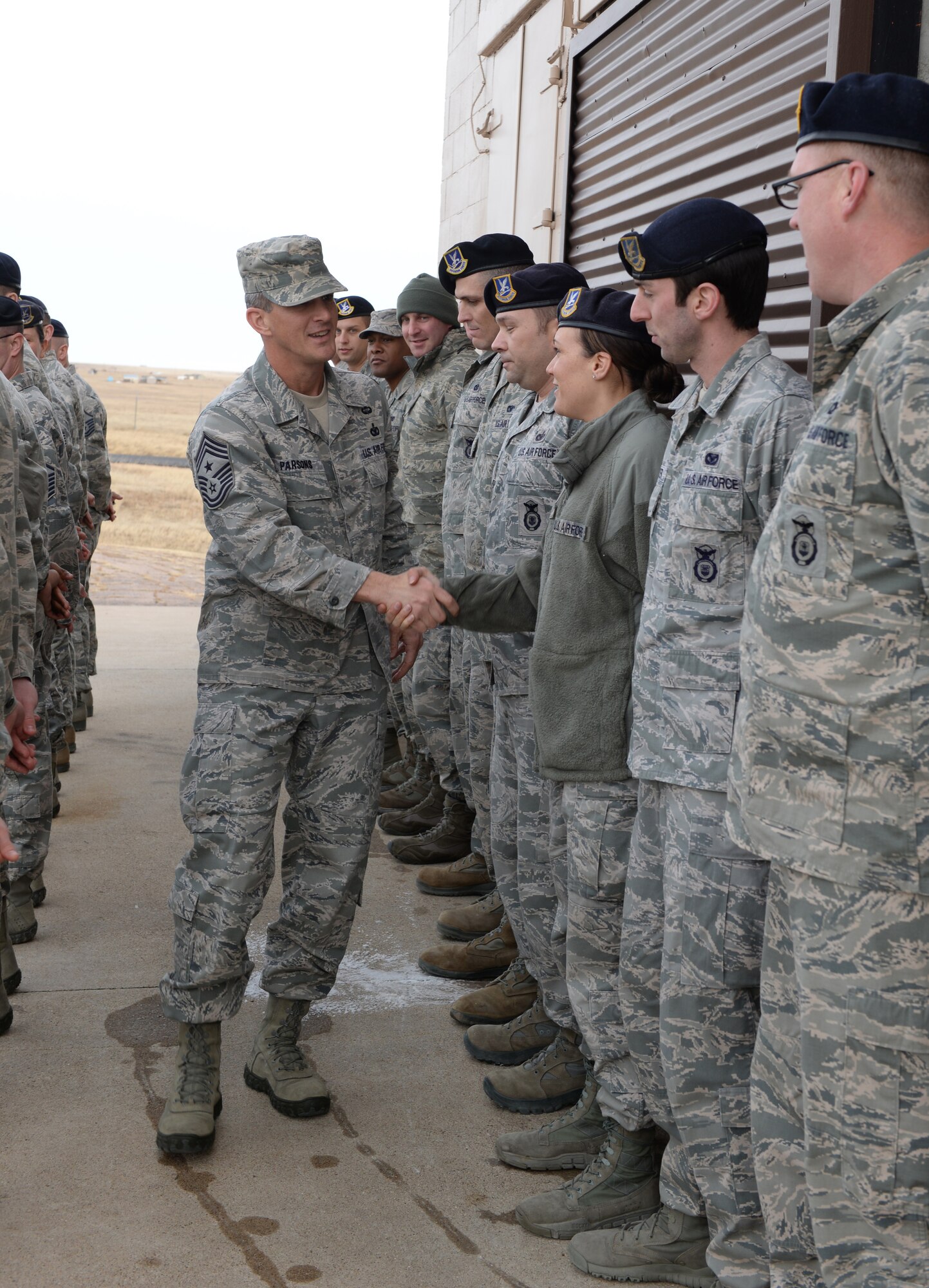 Chief Master Sgt. Richard Parsons, Air Combat Command command chief, greets Defenders from the 28th Security Forces Squadron outside the 28th SFS shoot house at Ellsworth Air Force Base, S.D. Jan. 29, 2014.  During his visit to the shoot house, Parsons learned more about how Defenders utilize the training facility to prepare, rapidly respond and deploy to an active shooter scenario. (U.S. Air Force photo by Airman 1st Class, Rebecca Imwalle/Released)