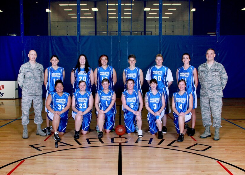 The Team Lady Falcons poses for a photo with Col. Brian Newberry, 92nd Air Refueling Wing commander, and Tech. Sgt. Noel Hachtel, coach, in the base gym at Fairchild Air Force Base, Wash., Feb. 1, 2014. The team consists of (front) Janneth Brown, Airman 1st Class Sarah Yeske, Senior Airman Erica Williams, Jodie Claypool, Staff Sgt. Karen Campbell, Alexa Reichensperger, (back) Staff Sgt. Cynthia Perez, Kora Kern, Emily Kern, Shannon Howard, Senior Airman Jessica Snyder and Staff Sgt. Kath Licht. (U.S. Air Force photo by Airman 1st Class Janelle Patiño/Released)