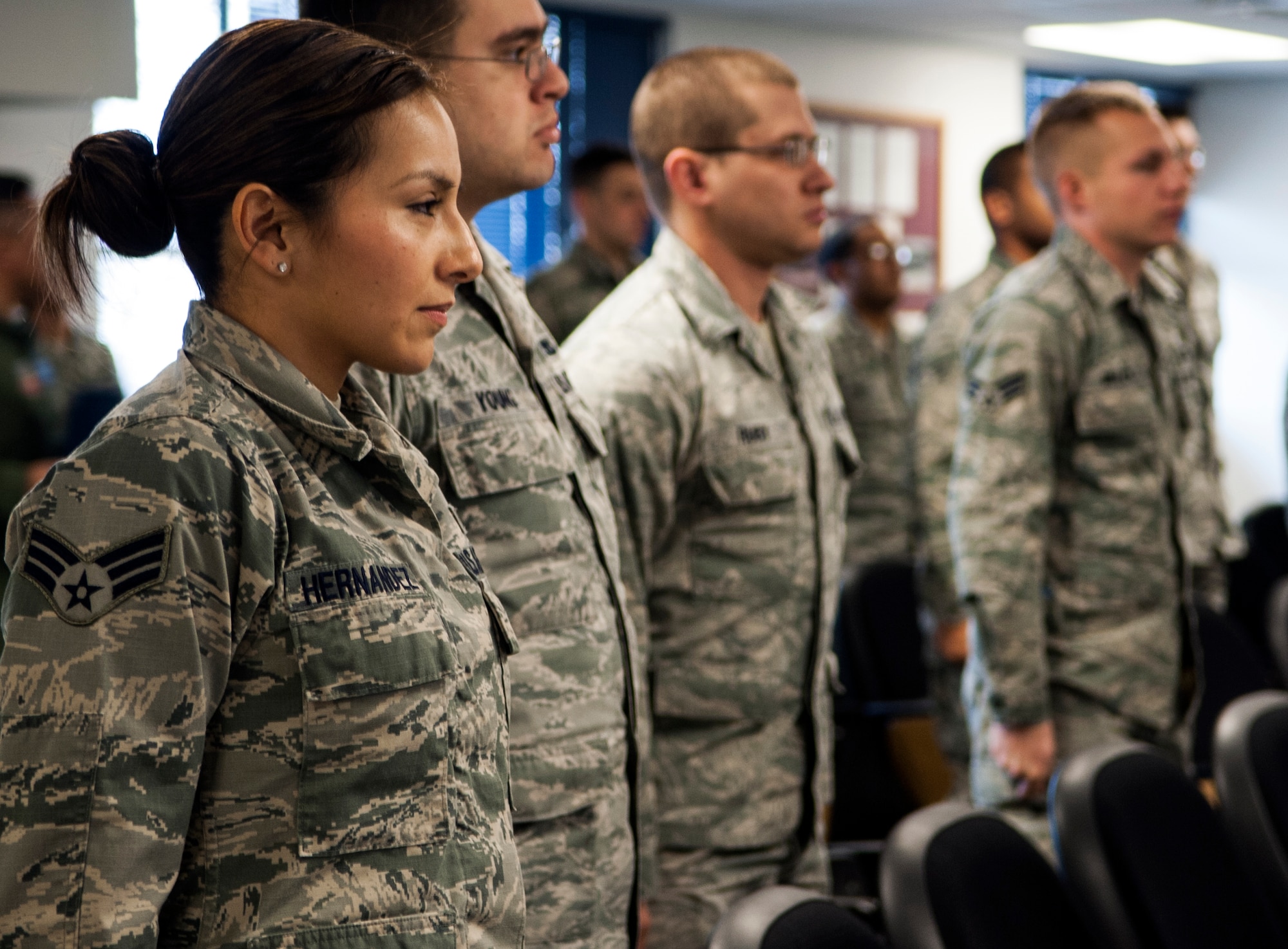 Senior Airman Myra Hernandez, 366th Medical Support Squadron nutritional medical technician, and fellow students at Airman Leadership School at Mountain Home Air Force Base, Idaho, stand at attention as Col. Sarady Tan enters the auditorium, Feb. 5, 2014. Tan, the 366th Medical Group commander, visited ALS to laud the students' and instructors' commitment, and to notify Hernandez she had been selected for a nine-month temporary duty assignment to perform with Tops In Blue. Hernandez, a 2007 Norta Vista High School graduate and Riverside, Calif., native, has been in the Air Force for five years. (U.S. Air Force photo by Master Sgt. Kevin Wallace/RELEASED)