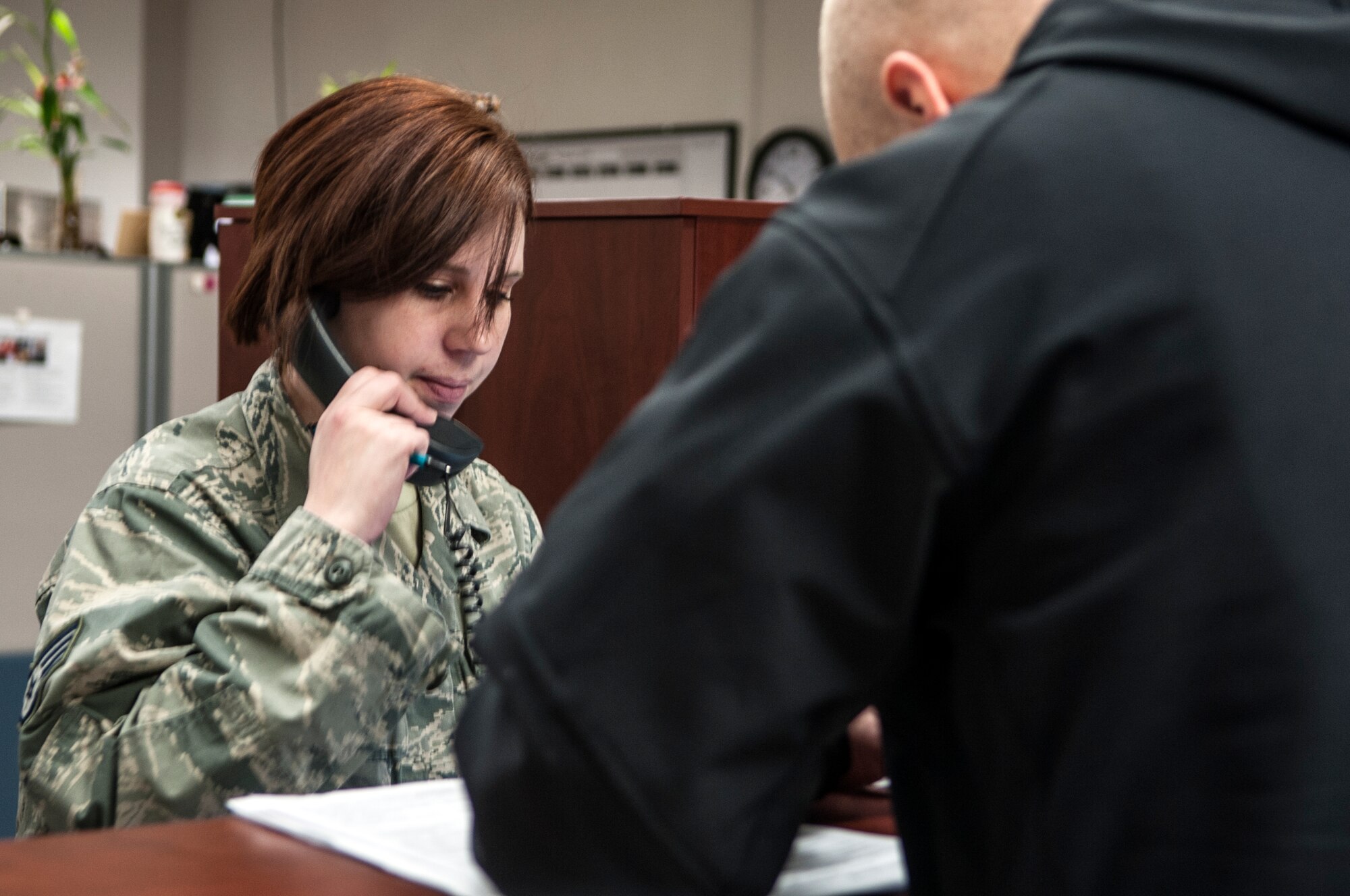 Staff Sgt. Vickie Erickson, 366th Comptroller Squadron financial management NCO, assists a customer with pay changes, as she verifies accuracy with the Defense Finance and Accounting Service at Mountain Home Air Force Base, Idaho, Feb. 5, 2014. Meticulous attention to detail and accuracy defines the 366th CPTS mission ethics and Erickson said their entire unit is motivated, mission focused and strives for 100 percent perfection in their duties. (U.S. Air Force photo by Master Sgt. Kevin Wallace/RELEASED)