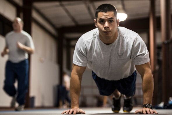 Senior Airman William Tibbetts, 366th Comptroller Squadron financial analyst and unit physical training leader, performs pushups during a CPTS PT session at Mountain Home Air Force Base, Idaho, Jan. 24, 2014. According to Senior Master Sgt. Kristina Ritz, 366th CPTS superintendent, sometimes Tibbett’s PT sessions are intense and result in aching muscles, sweat and exhaustion – and most consider that a good thing. (U.S. Air Force photo by Tech. Sgt. Samuel Morse/RELEASED)