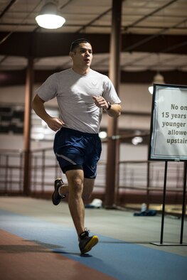 Senior Airman William Tibbetts, 366th Comptroller Squadron financial analyst and unit physical training leader, jogs during a 366th CPTS PT session at Mountain Home Air Force Base, Idaho, Jan. 24, 2014. Having deployed and gone on outside-the-wire missions, Tibbetts knows firsthand how important fitness is to being a ready Airman, so he balances it with other aspects of readiness and encourages others to do the same. (U.S. Air Force photo by Tech. Sgt. Samuel Morse/RELEASED)