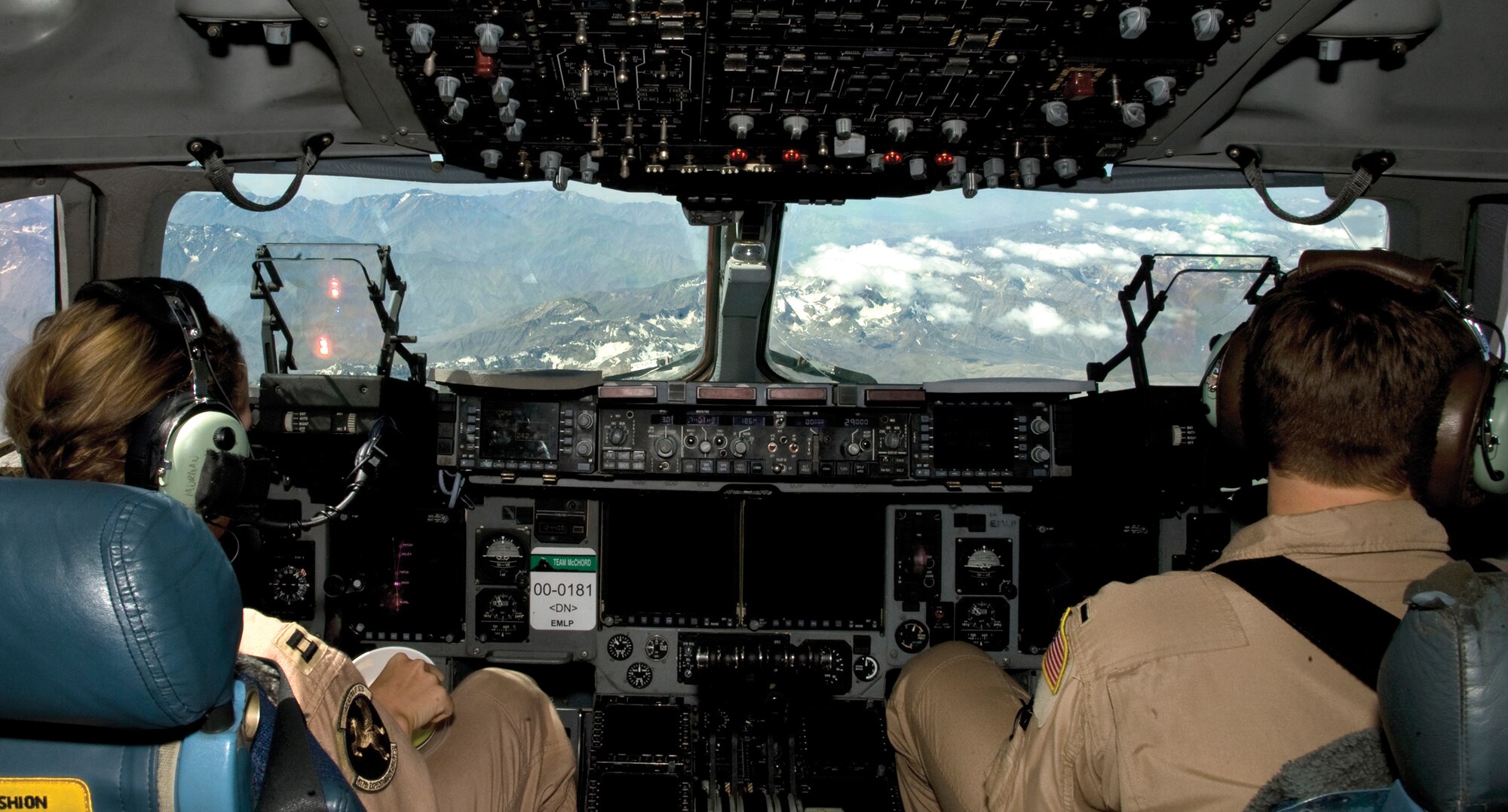 Capt Katrina Morgan, left, and 1Lt Jordan Bronson, right, 817th Expeditionary AS Detachment 1 pilots, conduct system management during flight with the help of autopilot. Autopilot helps reduce pilot fatigue during deployed missions that may last up to 16 hours. Capt Morgan and 1Lt Bronson are deployed out of Joint Base Lewis-McChord, Wash.