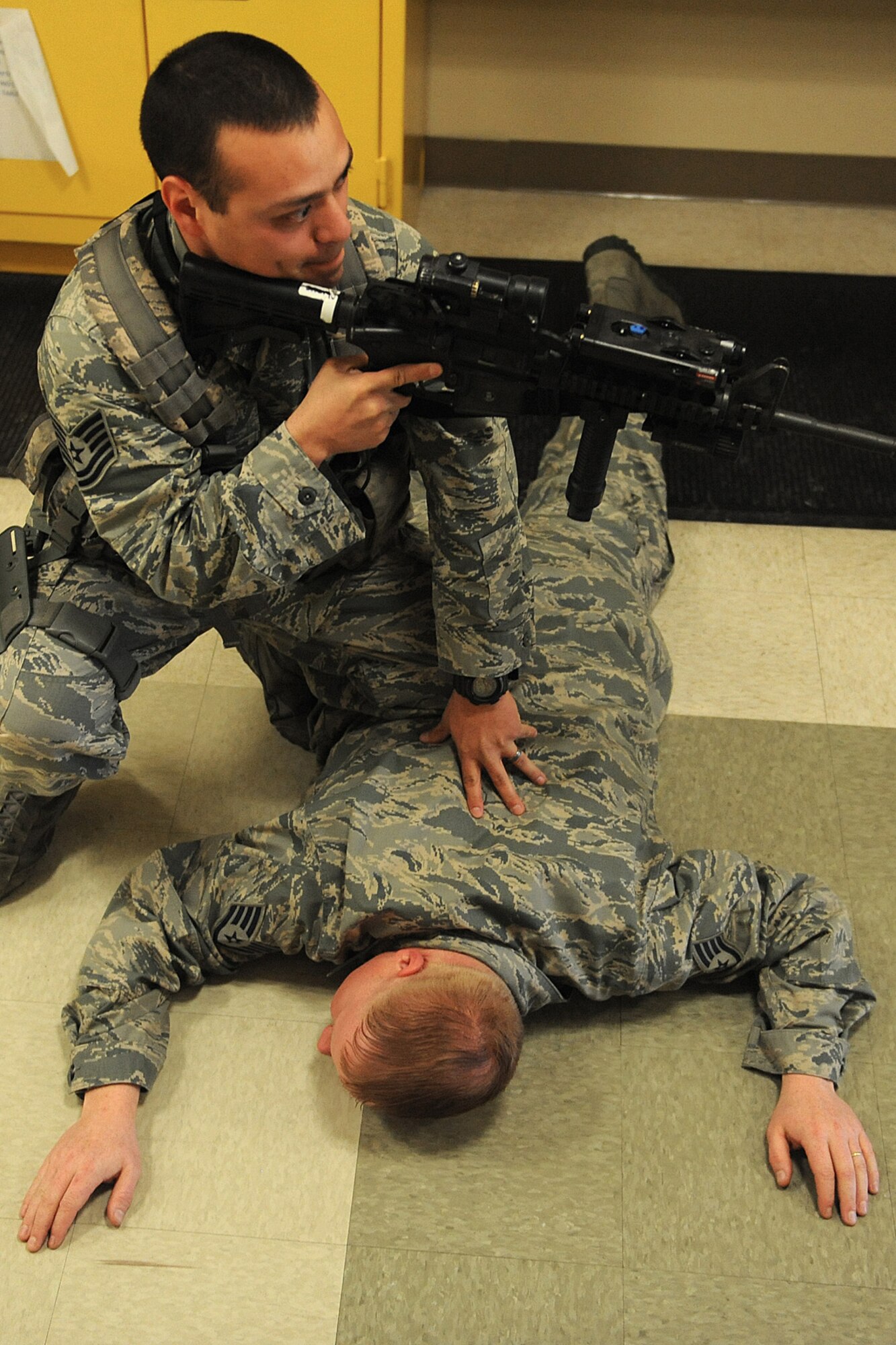 Tech. Sgt. Julio Joma takes down the active shooter during the training session Jan. 29, 2014 at Scott Air Force Base, Ill.  The scenario included a single shooter, and the Airmen had to seek this person out and disarm him.  Joma is a 375th SFS flight chief. (U.S. Air Force photo/Staff Sgt. Maria Bowman)