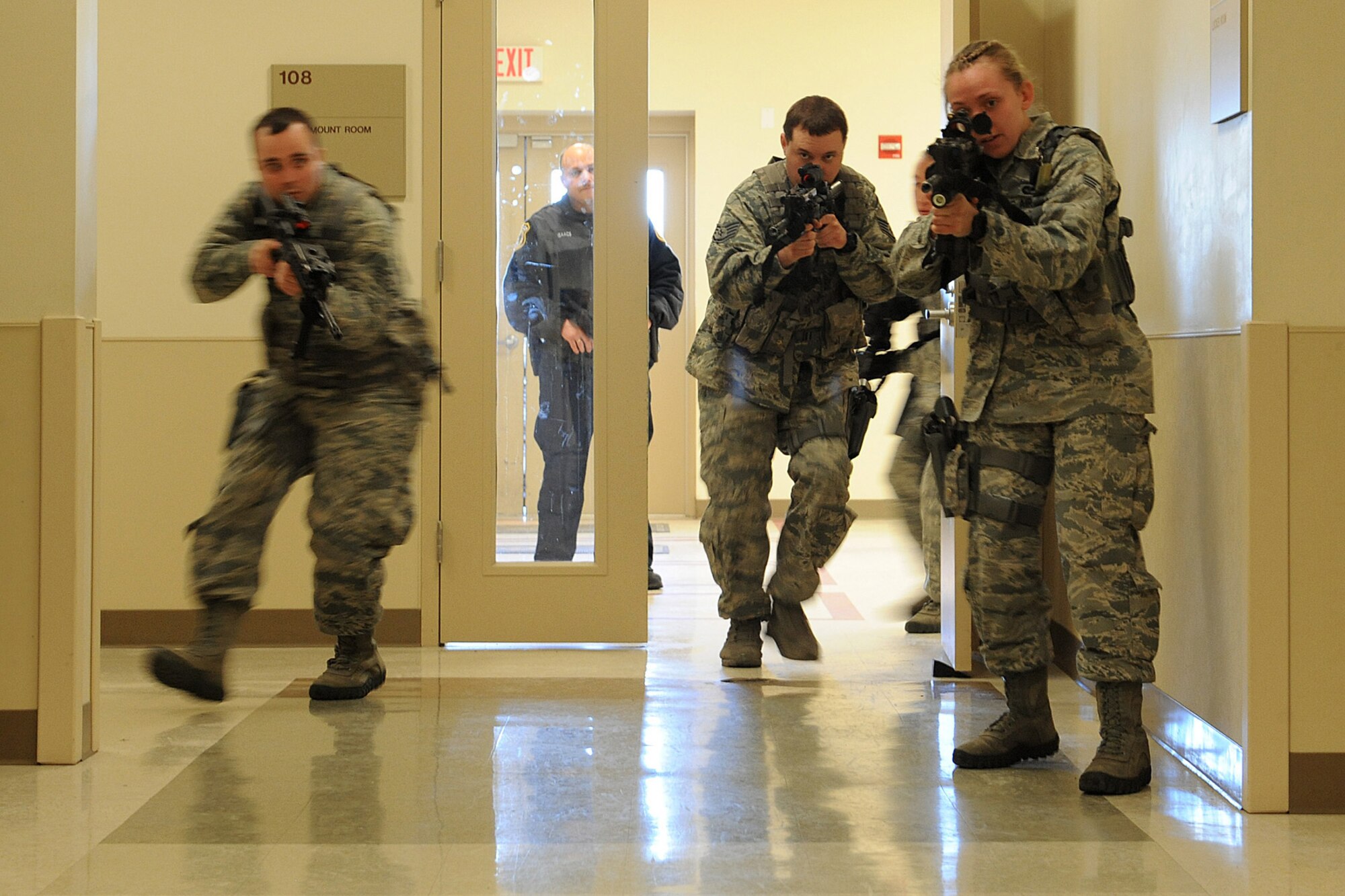 Airmen from the 375th Security Forces Squadron participate in active shooter training Jan. 29, 2014 at Scott Air Force Base, Ill.  The Airmen went through the hallways searching for the person who was acting out the role of an active shooter.  In 2009, Fort Hood, Texas, experienced an active shoooter incident and more recently so did the Navy Yard in Washington, D.C., so the 375th SFS trains on how to respond to them. (U.S. Air Force photo/Staff Sgt. Maria Bowman)