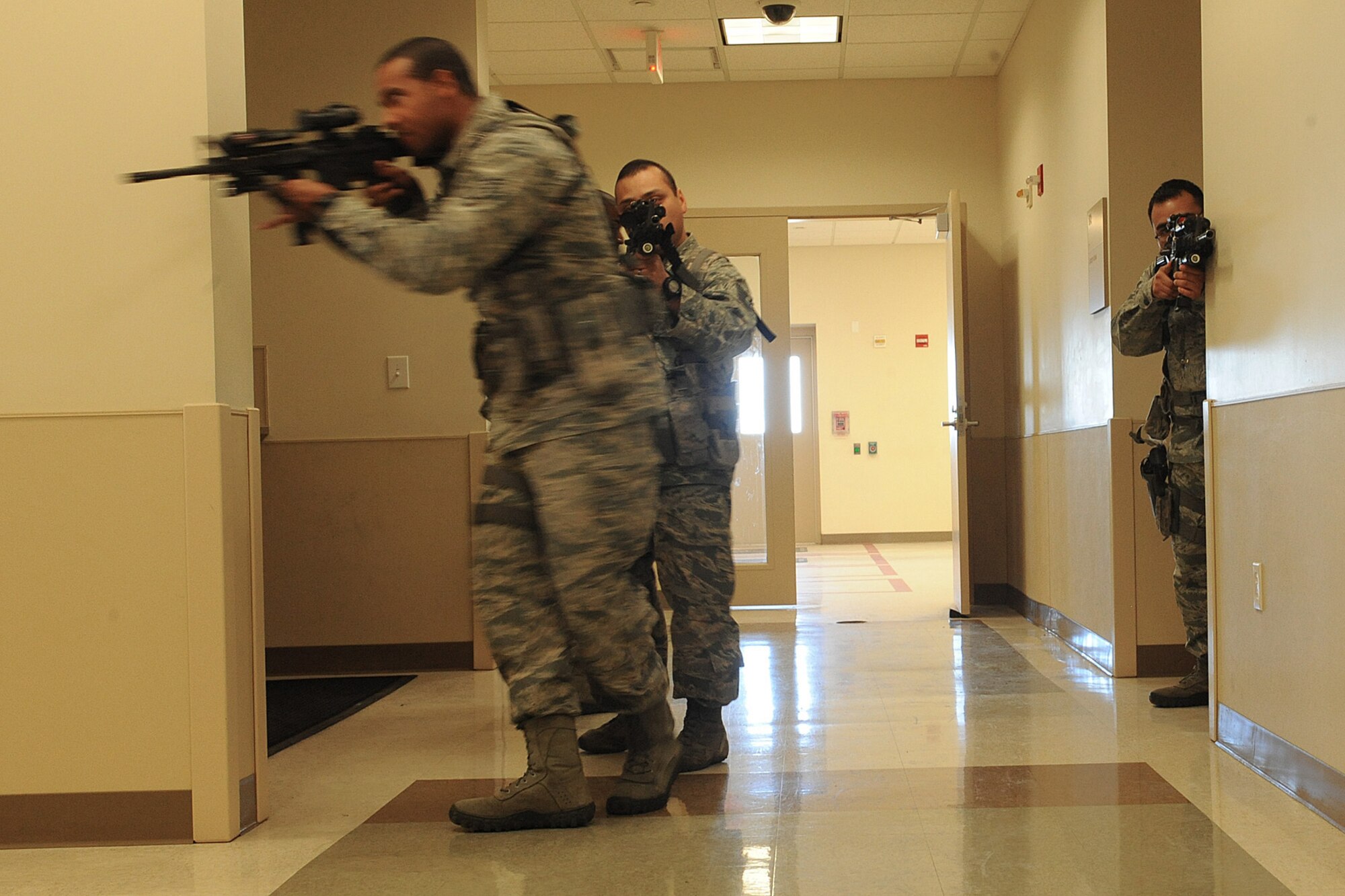Airmen from the 375th Security Forces Squadron participates in active shooter training Jan. 29, 2014 at Scott Air Force Base, Ill.  The Airmen went through the hallways searching for the person who was acting out the role of an active shooter.  Once the person was found, they disarmed and apprehended him. (U.S. Air Force photo/Staff Sgt. Maria Bowman)