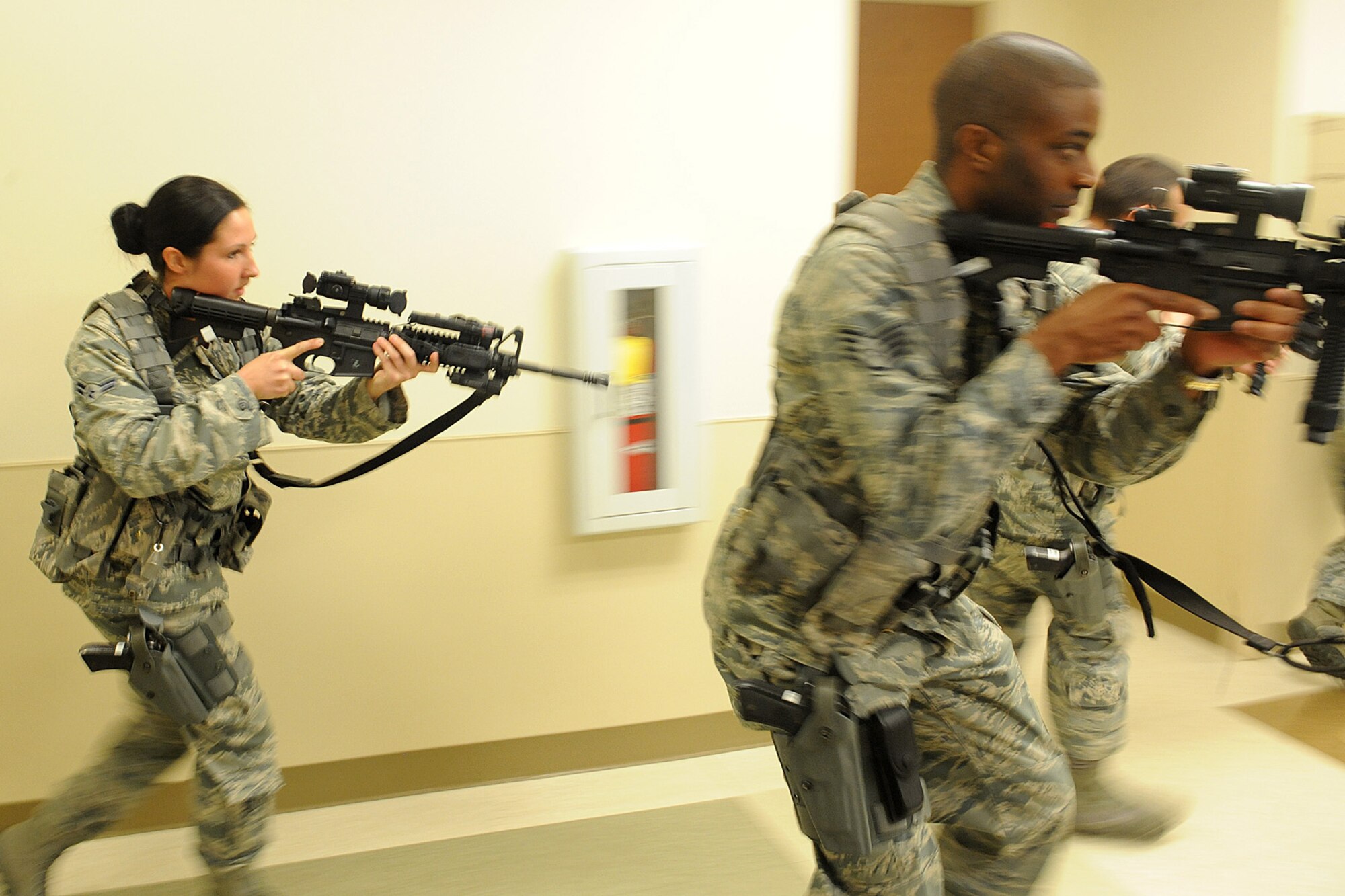 Airmen from the 375th Security Forces Squadron participate in active shooter training Jan. 29, 2014 at Scott Air Force Base, Ill.  The Airmen went through the hallways searching for the person who was acting out the role of an active shooter.  In 2009, Fort Hood, Texas, experienced an active shoooter incident and more recently so did the Navy Yard in Washington, D.C.  The 375th SFS trains in how to respond to active shooter scenarios. (U.S. Air Force photo/Staff Sgt. Maria Bowman)