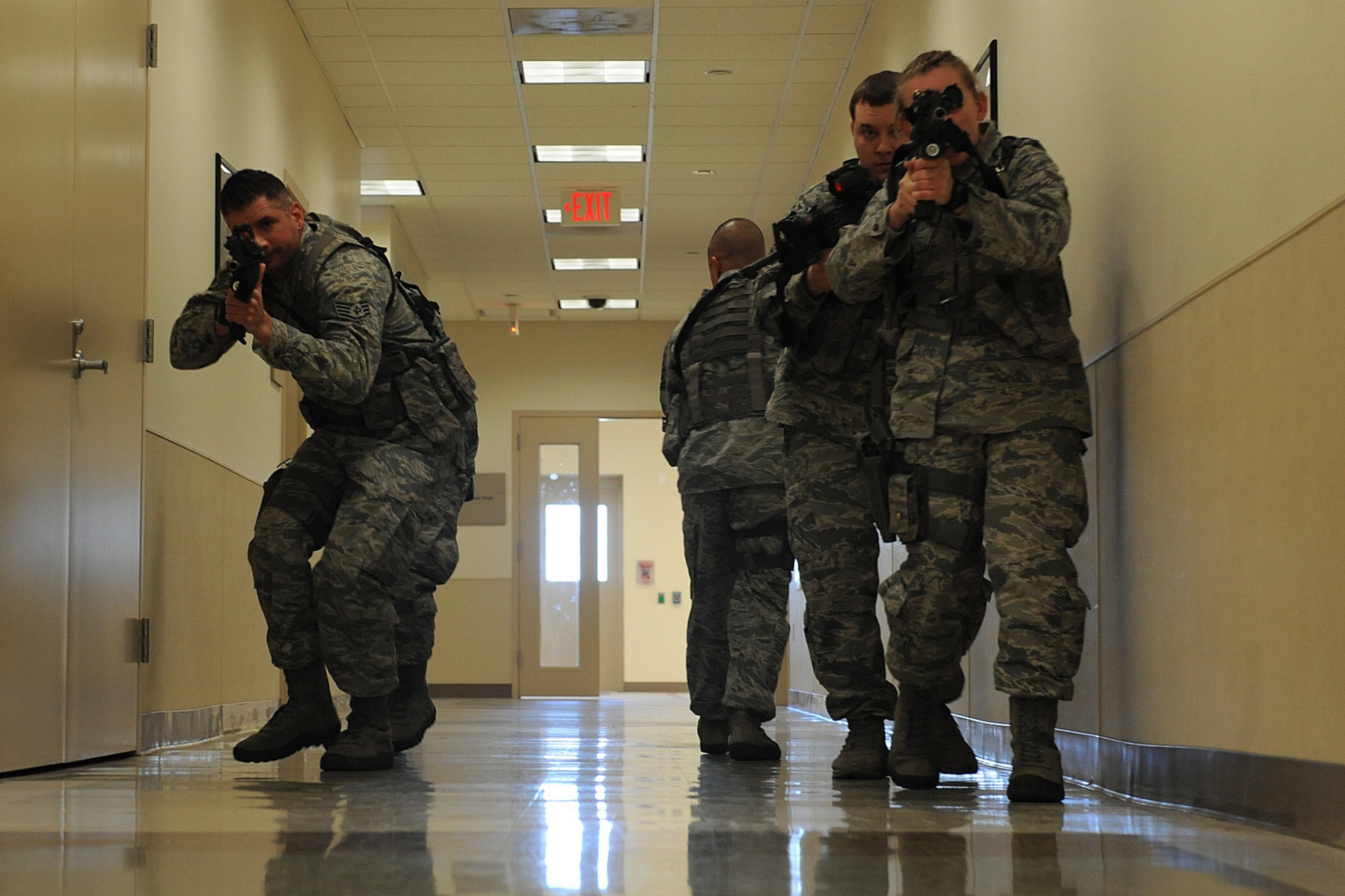 Airmen from the 375th Security Forces Squadron participate in active shooter training Jan. 29, 2014 at Scott Air Force Base, Ill.  The Airmen went through the hallways searching for the person who was acting out the role of an active shooter.  Once the person was found, they disarmed and apprehended him. (U.S. Air Force photo/Staff Sgt. Maria Bowman)