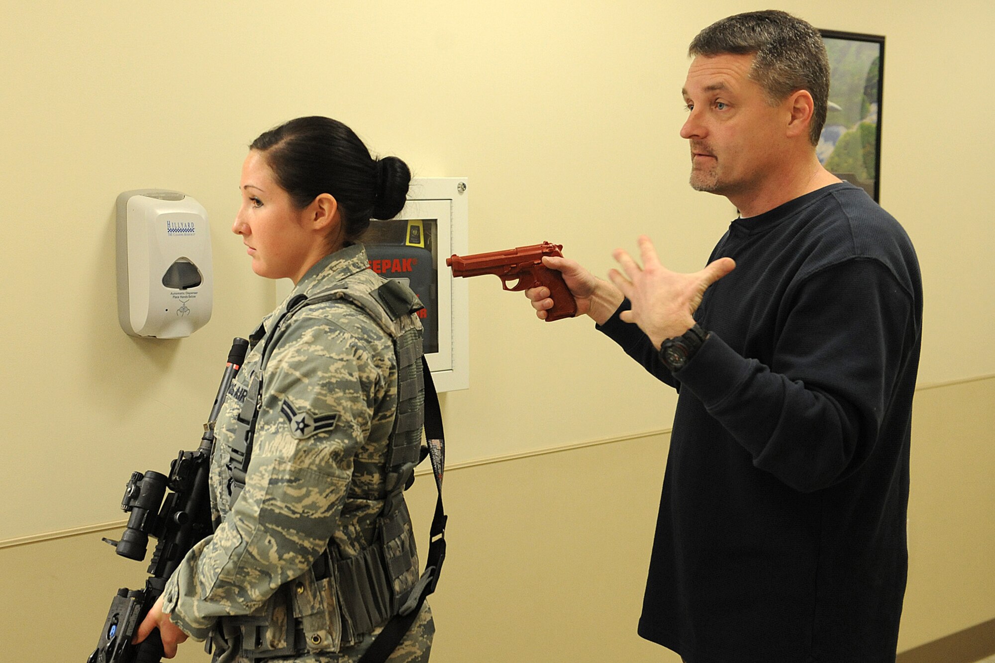 Joe Holtz instructs Airmen from the 375th Security Forces Squadron on how to safely turn a corner of a building during an active shooter training exercise Jan. 29, 2014 at Scott Air Force Base, Ill.  The 375th SFS trains on how to react to active shooters in different scenarios.  In 2009, Fort Hood, Texas, experienced an active shoooter incident and more recently so did the Navy Yard in Washington, D.C.  Holtz is a training instructor for the 375th SFS. (U.S. Air Force photo/Staff Sgt. Maria Bowman)