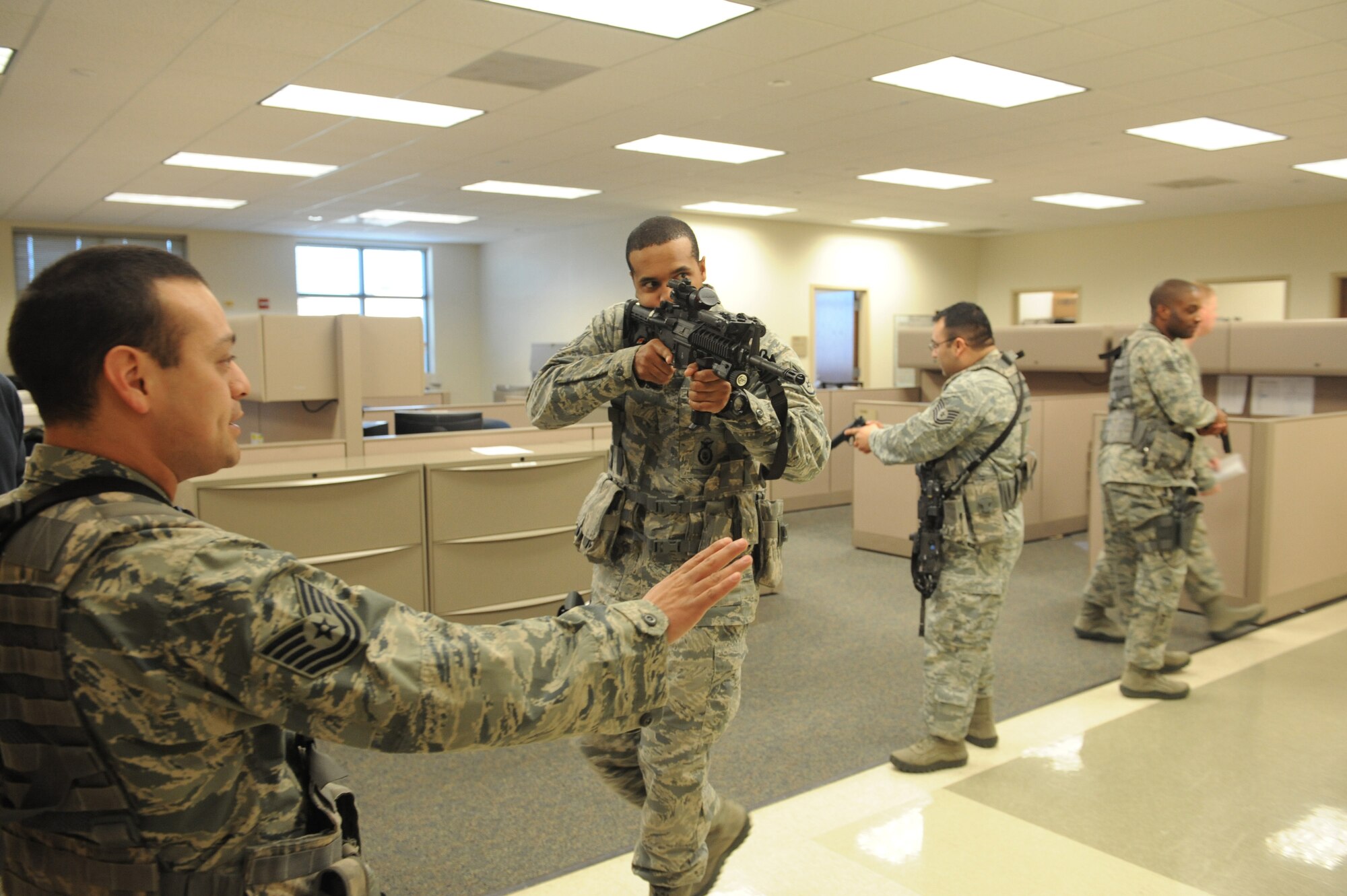 Airmen from the 375th Security Forces Squadron participate in active shooting training Jan. 29, 2014 at Scott Air Force Base, Ill.  The Airmen went through the hallways searching for the person who was acting out the role of an active shooter.  Once the person was found, they disarmed and apprehended him. (U.S. Air Force photo/Staff Sgt. Maria Bowman)