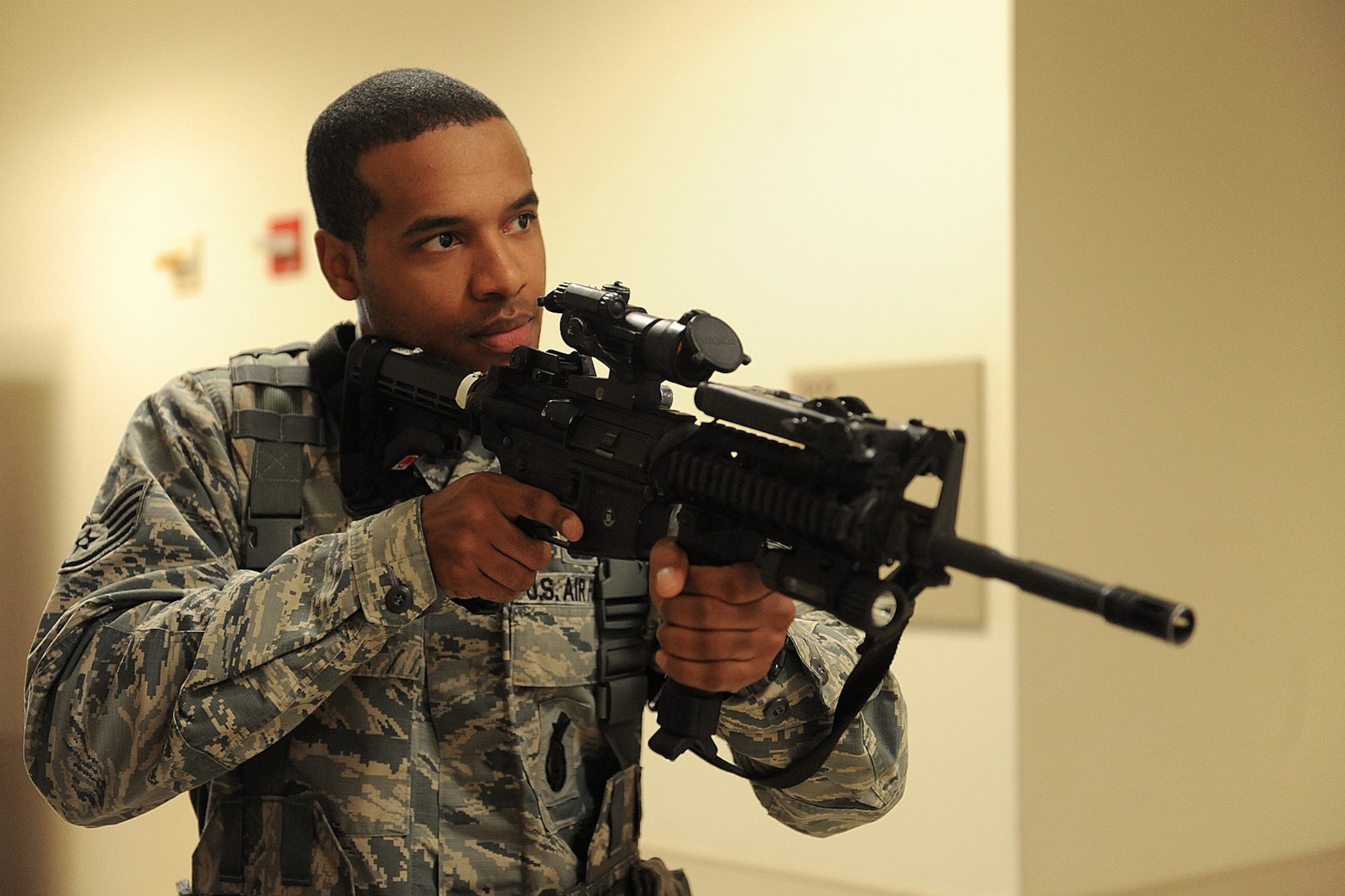Staff Sgt. Kenneth Francois walks down the hallway during a active shooter training Jan. 29, 2014 at Scott Air Force Base, Ill.  The scenario included a single shooter, and the Airmen had to seek this person out and disarm him. Francois is a 375th Security Forces Squadron defender. (U.S. Air Force photo/Staff Sgt. Maria Bowman)