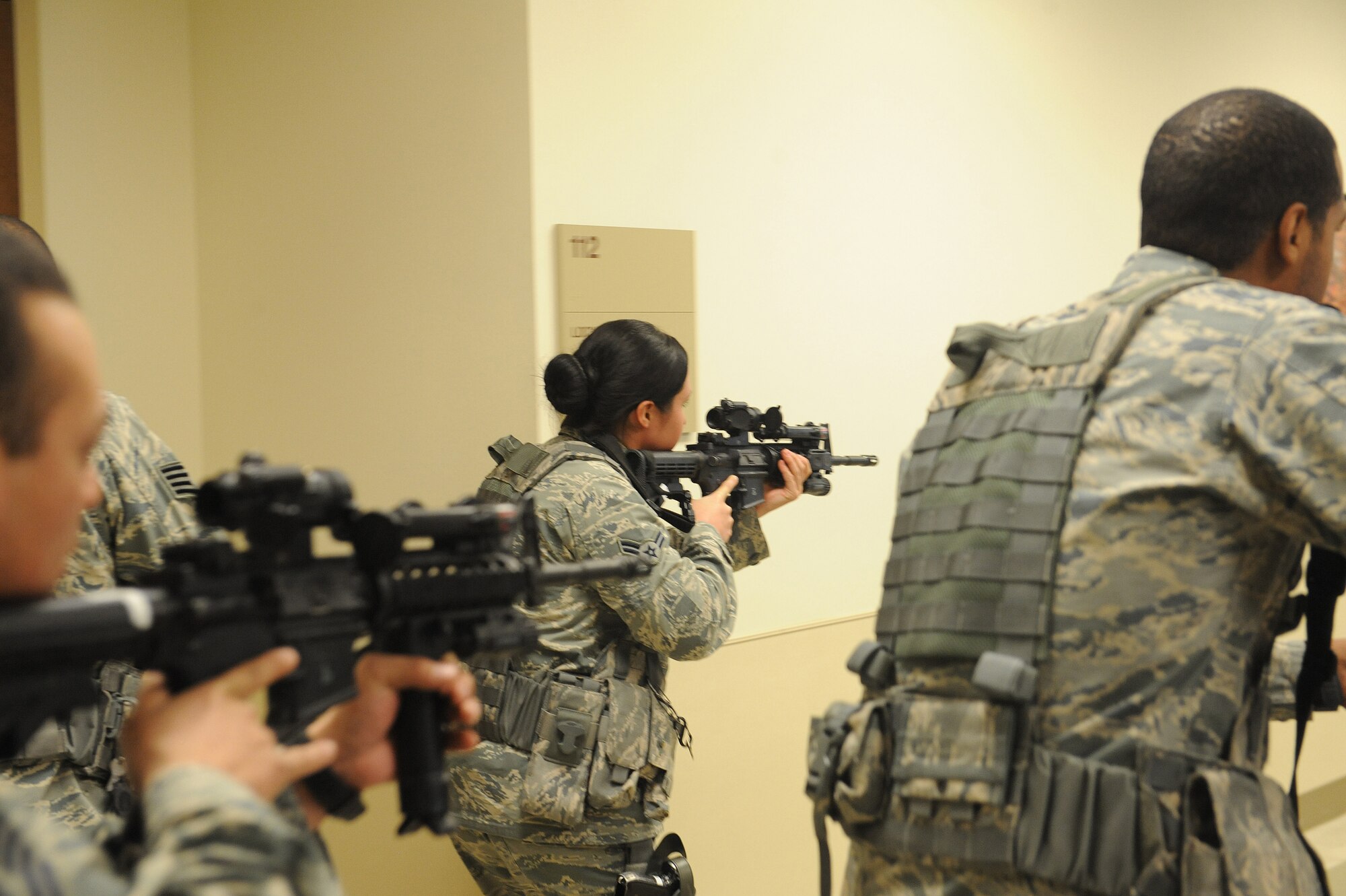 Airmen from the 375th Security Forces Squadron participate in active shooting training Jan. 29, 2014 at Scott Air Force Base, Ill.  The Airmen went through the hallways searching for the person who was acting out the role of an active shooter.  Once the person was found, they disarmed and apprehended him. (U.S. Air Force photo/Staff Sgt. Maria Bowman)