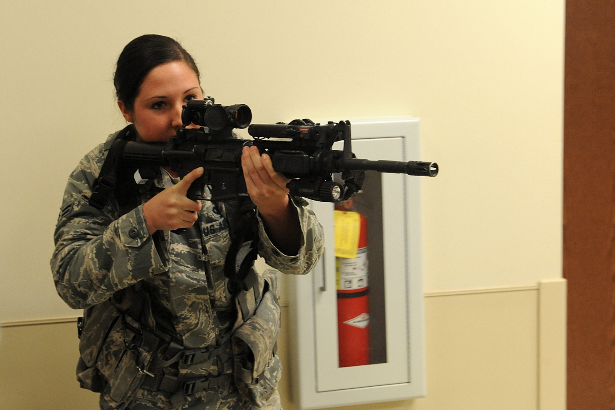 Airman 1st Class Raye Feezor, from the 375th Security Forces Squadron, participates in active shooting training Jan. 29, 2014 at Scott Air Force Base, Ill.  The Airmen went through the hallways searching for the person who was acting out the role of an active shooter.  Once the person was found, they disarmed and apprehended him.  Feezor is a 375th SFS defender.  (U.S. Air Force photo/Staff Sgt. Maria Bowman)