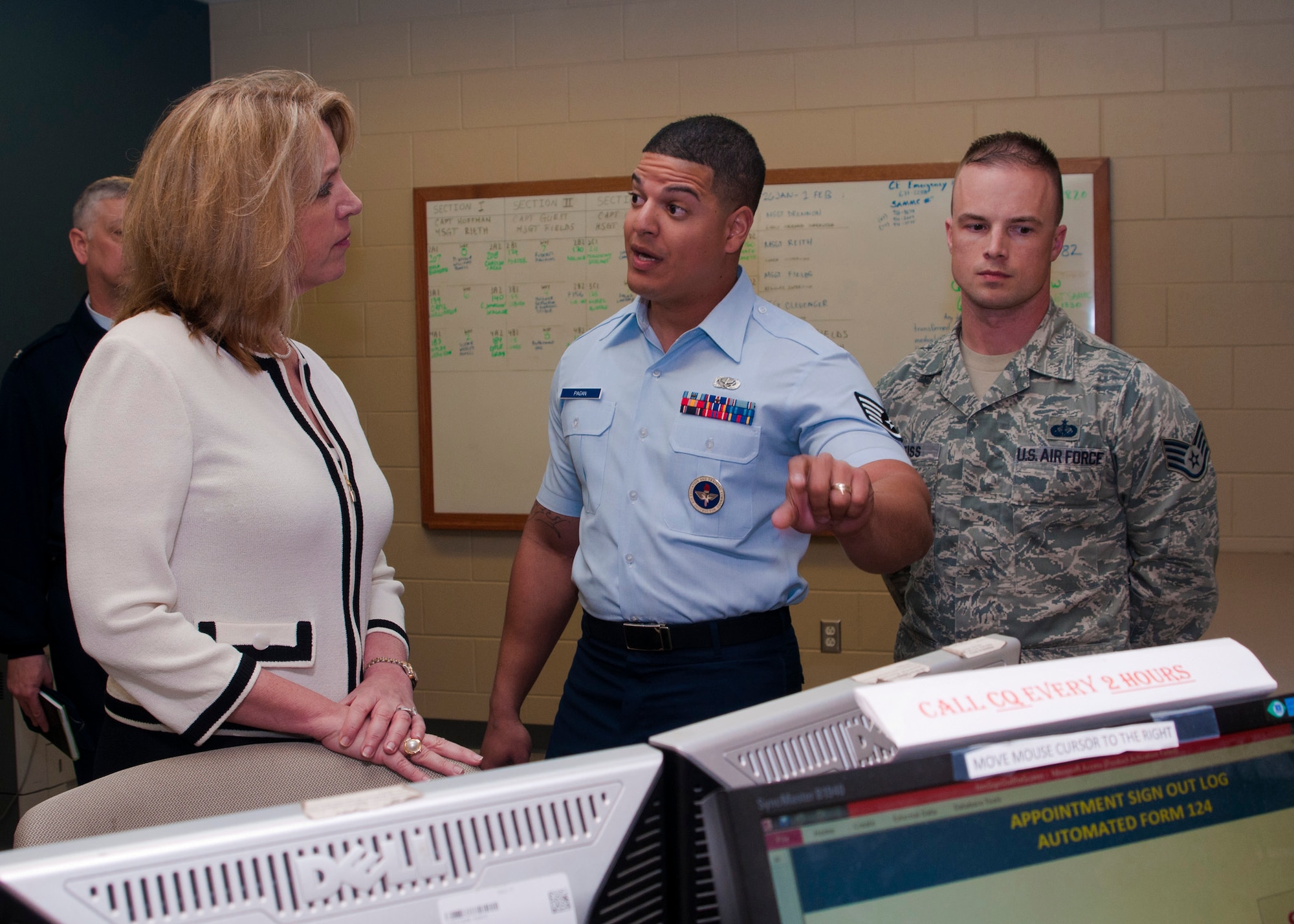 Secretary of the Air Force Deborah Lee James is briefed on the command of quarters procedures by Tech. Sgt. Christian Pagan-Guzman and Staff Sgt. Dennis Weiss, both military training instructors with the 323rd Training Squadron, during a tour of the 323rd Training Squadron facilities Jan. 31 at Joint Base San Antonio-Lackland, Texas. The SecAF made her first visit to Joint Base San Antonio Jan. 30-31 where she received a mission brief of the 37th Training Wing, discussed the way ahead with installation leadership and held an all call with Air Education and Training personnel at JBSA-Randolph. (U.S. Air Force photo by Staff Sgt. Marissa Tucker)