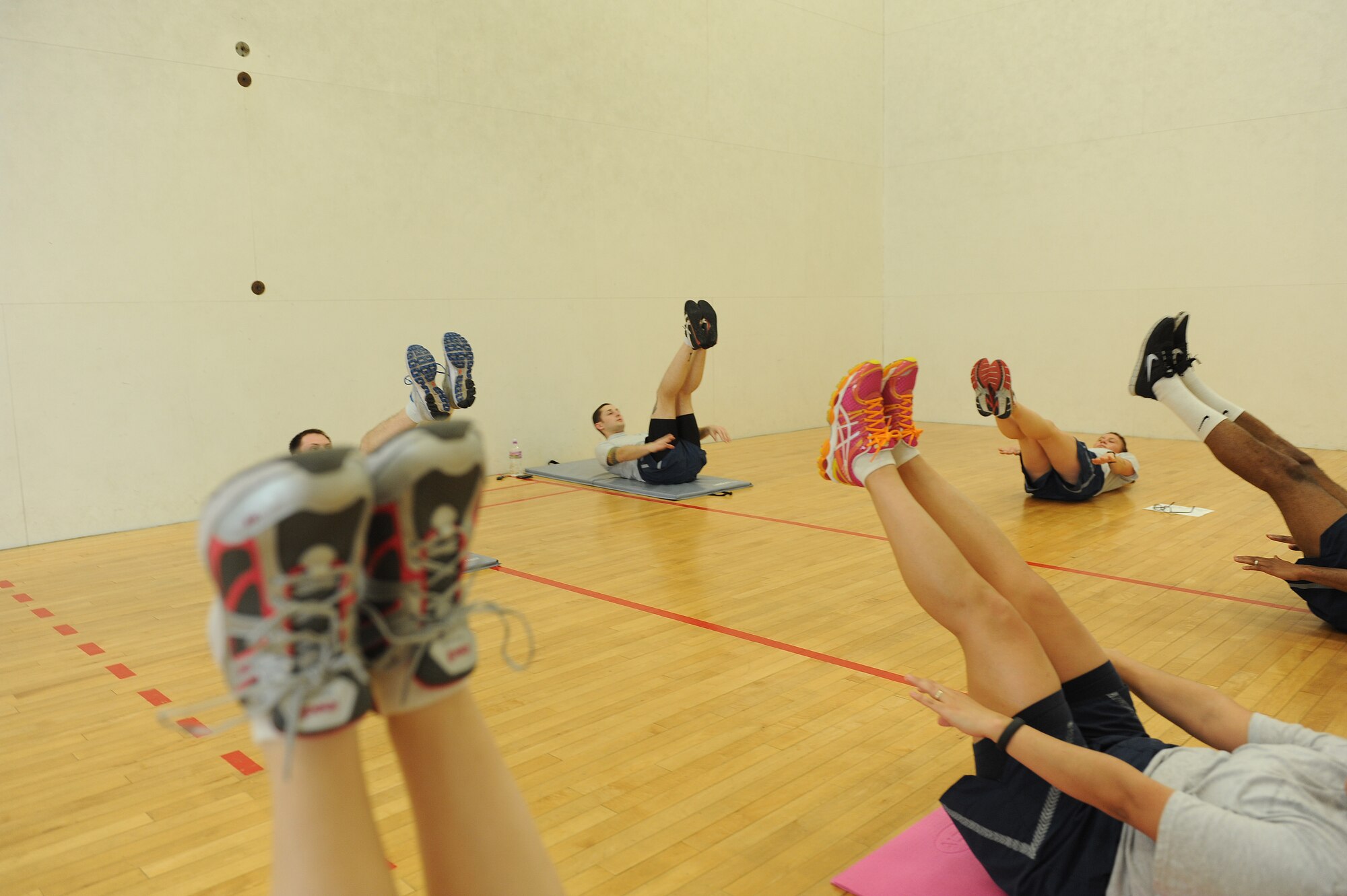 Scott Airmen exercise Feb. 3, 2014, in the racquetball court at the James Gym. New Air Force regulations allow for more shoe and clothing options. (U.S. Air Force photo/Airman 1st Class Josh Eikren)