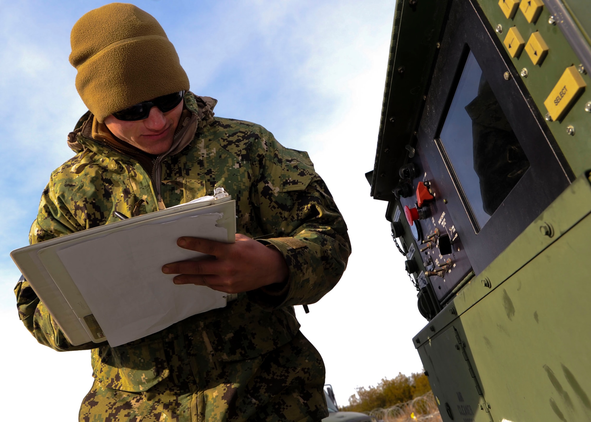 U.S. Navy Seaman Apprentice Michael Hopkins, Coastal Riverine Squadron 2, B Company construction mechanic, records fuel levels and other metrics during a training exercise at Fort Eustis, Va., Jan. 23, 2014. CRS2 B Co. and A Co. utilized Fort Eustis’ 3rd Port to launch their boats.  (U.S. Air Force photo by Airman 1st Class Austin Harvill/Released)