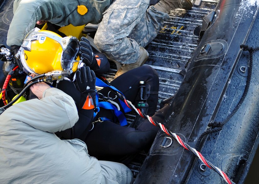 U.S. Army Capt. Brian Wilson, 20th Engineer Brigade, 30th Eng. Battalion, 74th Eng. Detachment commander, prepares to dive during a pier repair mission at Fort Eustis, Va., Jan. 30, 2014. Army divers were sent out in support of Operations Iraqi Freedom, Enduring Freedom and Unified Response. (U.S. Air Force photo by Airman 1st Class Austin Harvill/Released)