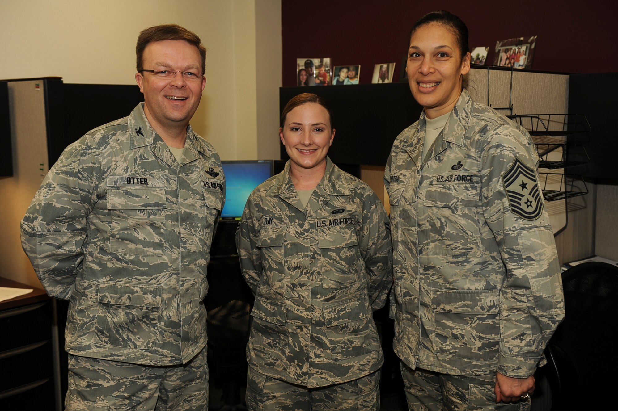 Airman 1st Class Emily Day, a 19th Comptroller Squadron civilian pay technician, is congratulated by Col. William Otter, 19th Airlift Wing vice commander, and Chief Master Sgt. Margarita Overton, 19th Airlift Wing command chief, for her selection as this week’s Combat Airlifter. Day created a civilian pay spreadsheet and managed 948 civilian timecards to ensure all civilians were paid during the government shutdown. (U.S. Air Force photo by Airman 1st Class Cliffton Dolezal)