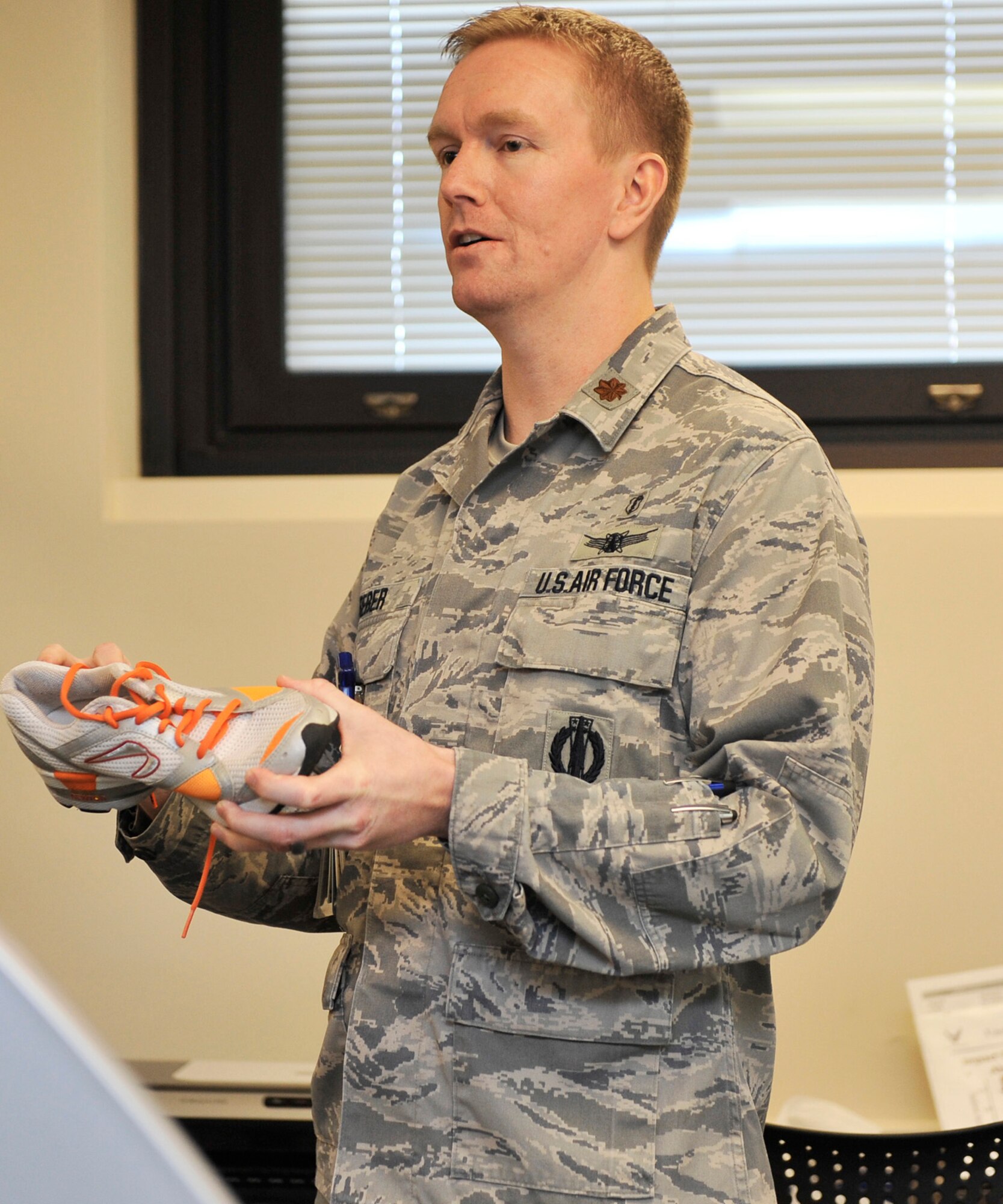 Maj. Rett Reber talks about the different running shoes and techniques involved in becoming a better runner. As part of a tour given Jan. 29 during Biomedical Sciences Corps week of events. Maj. Rett Reber is a part of the physical therapy clinic in the 375th Medical Group. (U.S. Air Force photo/Airman 1st Class Kiana Brothers)
