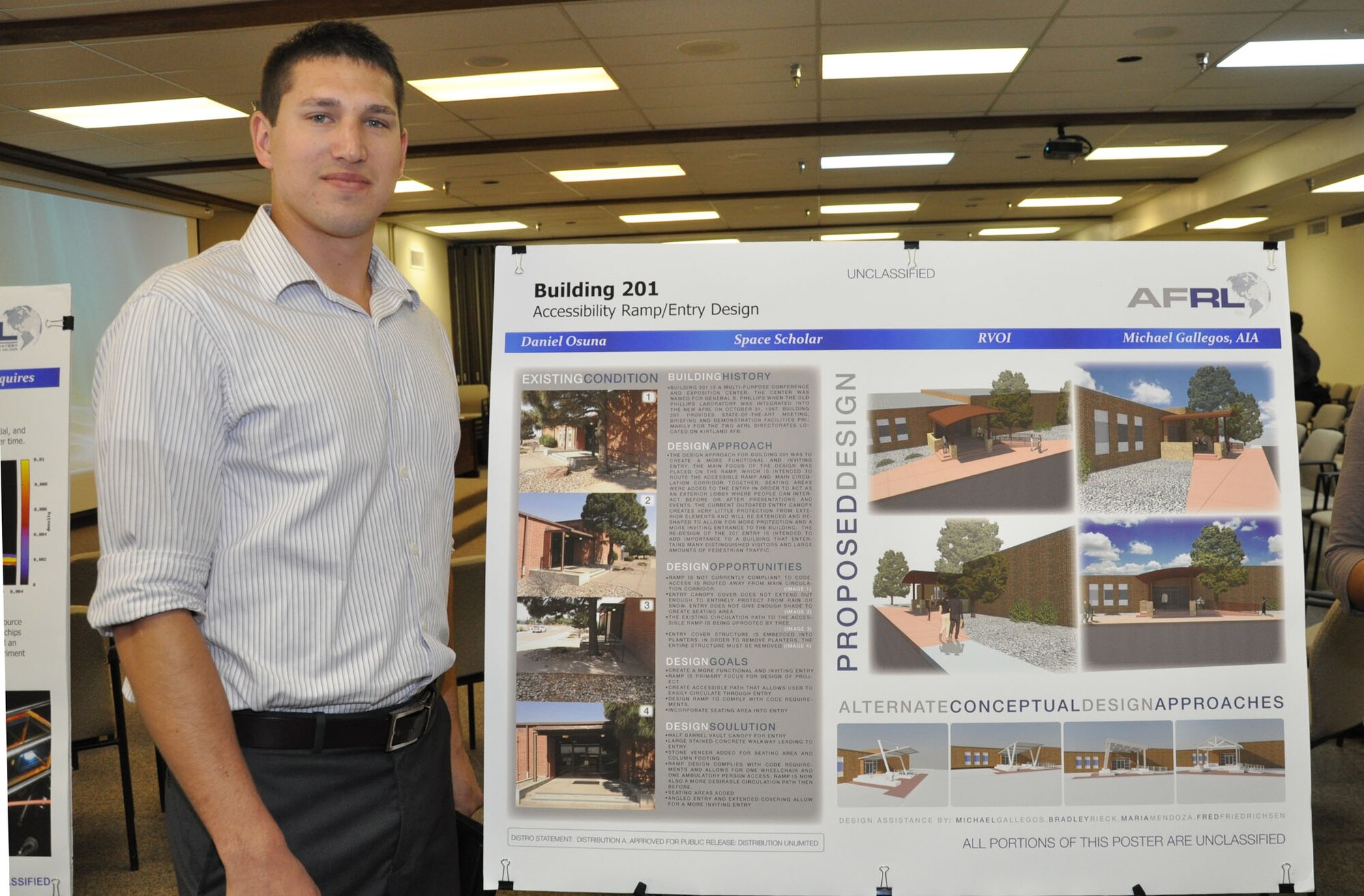 Air Force Research Laboratory Scholar Daniel Osuna exhibits his winning design at the AFRL Scholars poster review May 2012.  Kirtland's Civil Engineer Division approved his design for construction of a new entryway for the AFRL Phillips Space Conference Center, and construction began in January. (Photo by Anita Collins)