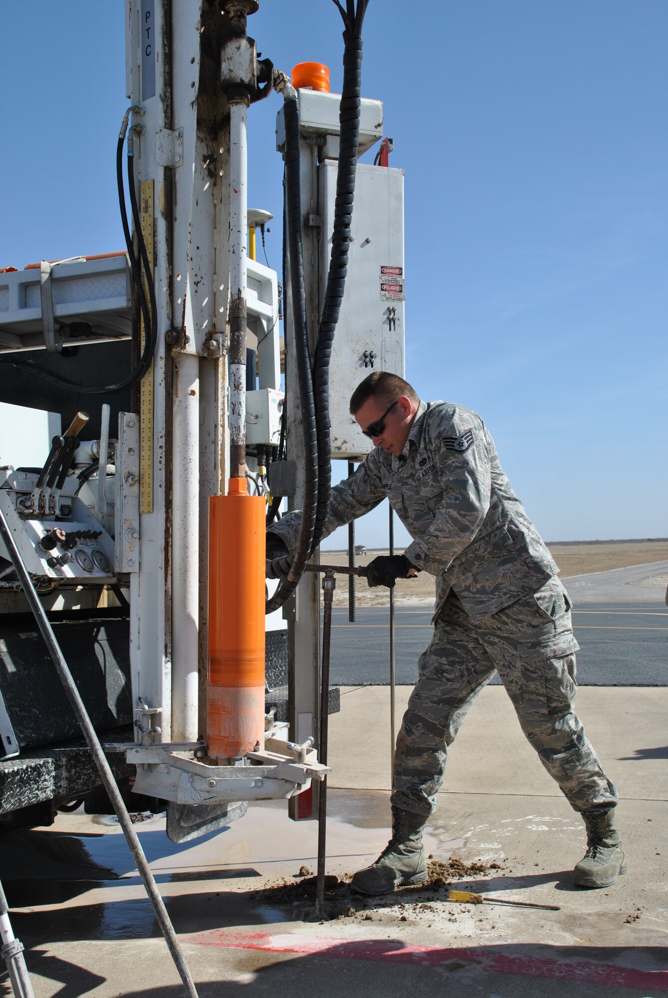 SPOFFORD, Texas -- Staff Sgt. Travis Ripple, a member of AFCEC's Airfield Pavement Evaluation Team, uses an auger to remove different soil layers during a destructive test on the airfield here. (U.S. Air Force photo/Michael Briggs) 