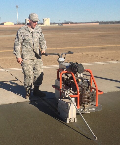 Senior Airman Tim Jechort, 2nd CES pavements and equipment journeyman, cuts  contraction joints in concrete on Barksdale Air Force Base. The 2nd CES dirt boys maintain the airfield so the B-52H Stratofortress can take off safely. (U.S. Air Force/Courtesy photo)