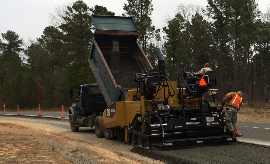 2nd CES dirt boys lay down a mat of base course and compact it with a vibratory roller on Barksdale Air Force Base. The base course provides a solid foundation for the asphalt mat that will be used for the East Reservation running path. (U.S. Air Force/Courtesy photo)