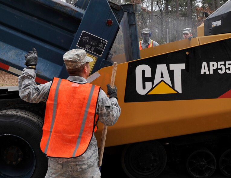 Senior Airmen Anthony Ohl and Xavier Newton, 2nd CES pavements and equipment journeymen, discuss the next step of laying the base course on Barksdale Air Force Base, Jan. 31, 2014. The base course provides a solid foundation for the asphalt mat that will be laid on top of the base course. (U.S. Air Force Photo/Airman 1st Class Benjamin Raughton) 