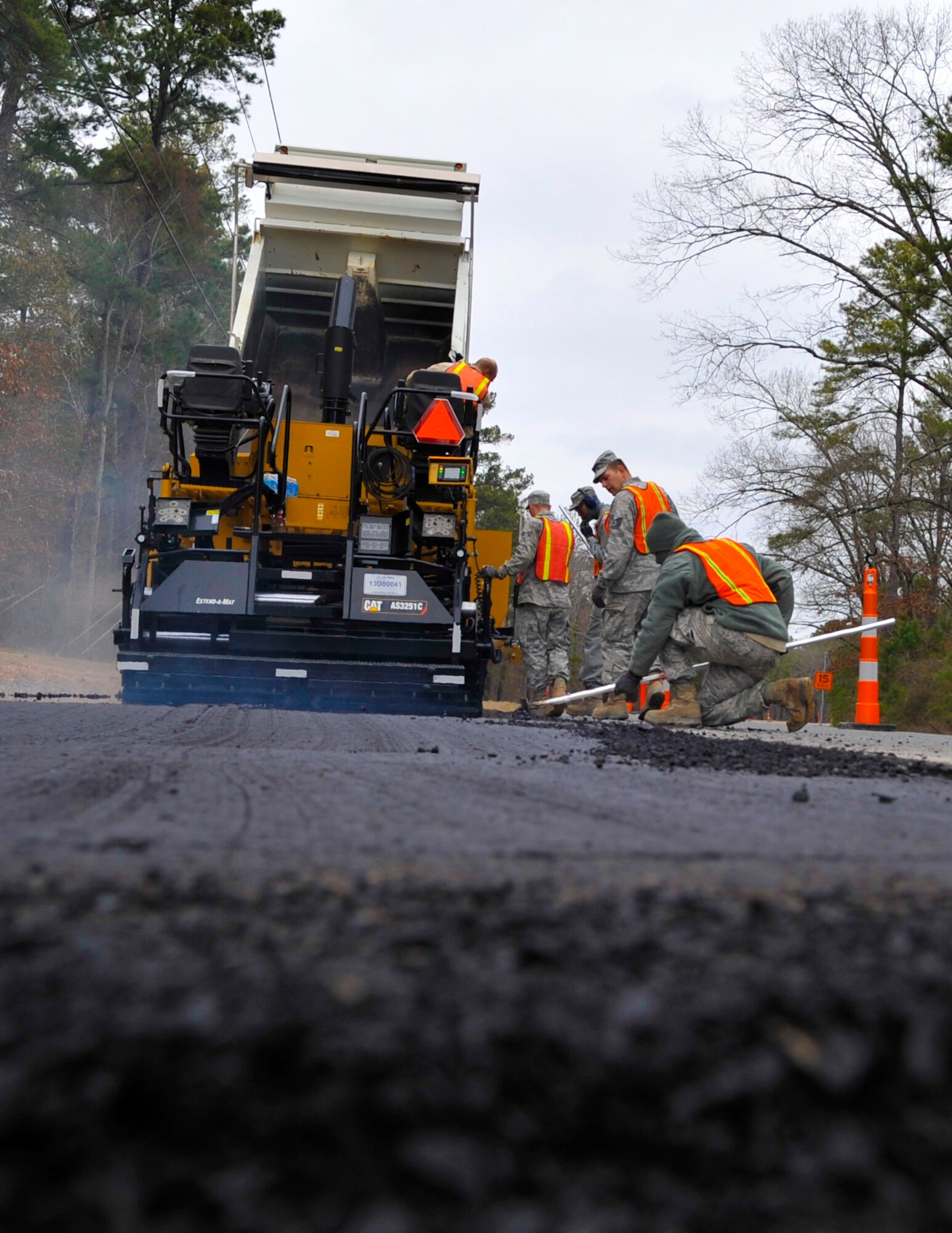 2nd Civil Engineer Squadron dirt boys lay down a mat of base course near Fire Station 3 on Barksdale Air Force Base, Jan. 31, 2014. The dirt boys are the 2nd CES construction element for any horizontal surface. (U.S. Air Force Photo/Airman 1st Class Benjamin Raughton)