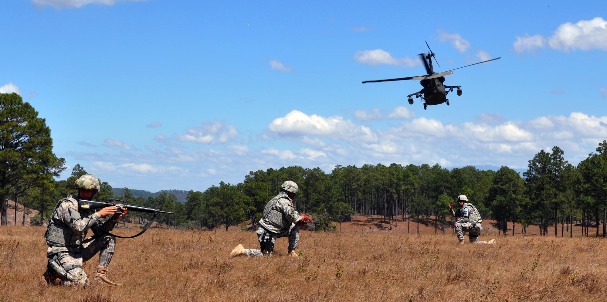 Members of Joint Task Force Bravo's Joint Security Forces Squadron provide security as a UH-60 Blackhawk helicopter lifts off during a personnel and downed aircraft recovery exercise in Honduras, Feb. 4, 2014.  The purpose of the exercise was to validate the unit's ability to immediately support a personnel recovery in the event of a downed aircraft. (U.S. Air Force photo by Capt. Zach Anderson)