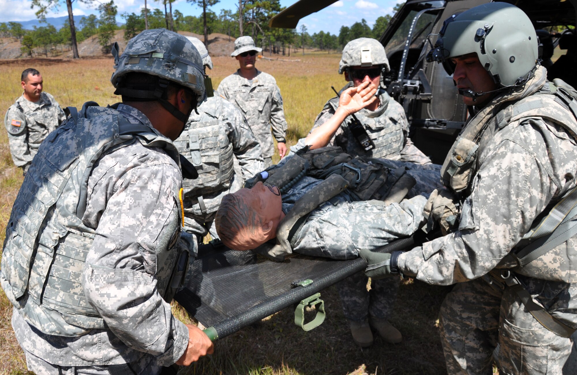 Members of Joint Task Force Bravo's Joint Security Forces Squadron and 1-228th Aviation Regiment extract a simulated injured aircrew member from a UH-60 Blackhawk helicopter during a personnel and downed aircraft recovery exercise in Honduras, Feb. 4, 2014.  The purpose of the exercise was to validate the unit's ability to immediately support a personnel recovery in the event of a downed aircraft. (U.S. Air Force photo by Capt. Zach Anderson)