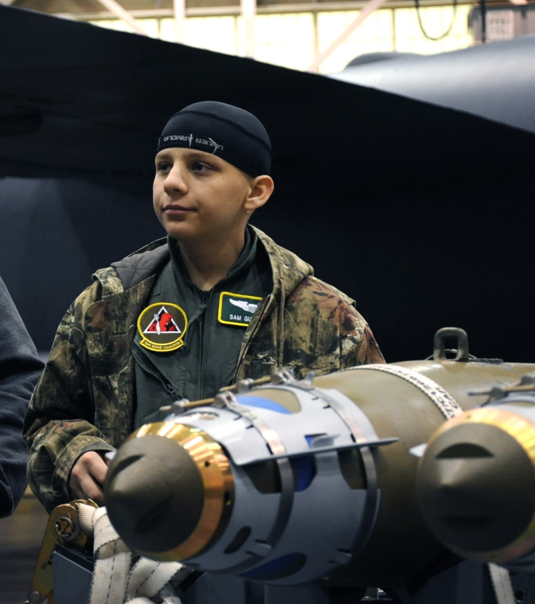 Sam Guimaraes, 17-year-old Alexandria, La. native, listens to a brief about the Guided Bomb Unit during his visit to Barksdale Air Force Base, La., as part of the Pilot for a Day program, Jan. 4, 2014. The goal of the Pilot for a Day program is to provide children, who have serious or chronic medical conditions, and their families the opportunity to experience the life of an aircrew member. (U.S. Air Force photo/Staff Sgt. Sean Martin)


