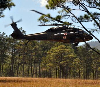 A UH-60 Blackhawk lifts off while carrying a simulated injured aircrew member during a personnel and downed aircraft recovery exercise in Honduras, Feb. 4, 2014.  The purpose of the exercise was to validate the unit's ability to immediately support a personnel recovery in the event of a downed aircraft. (U.S. Air Force photo by Capt. Zach Anderson)